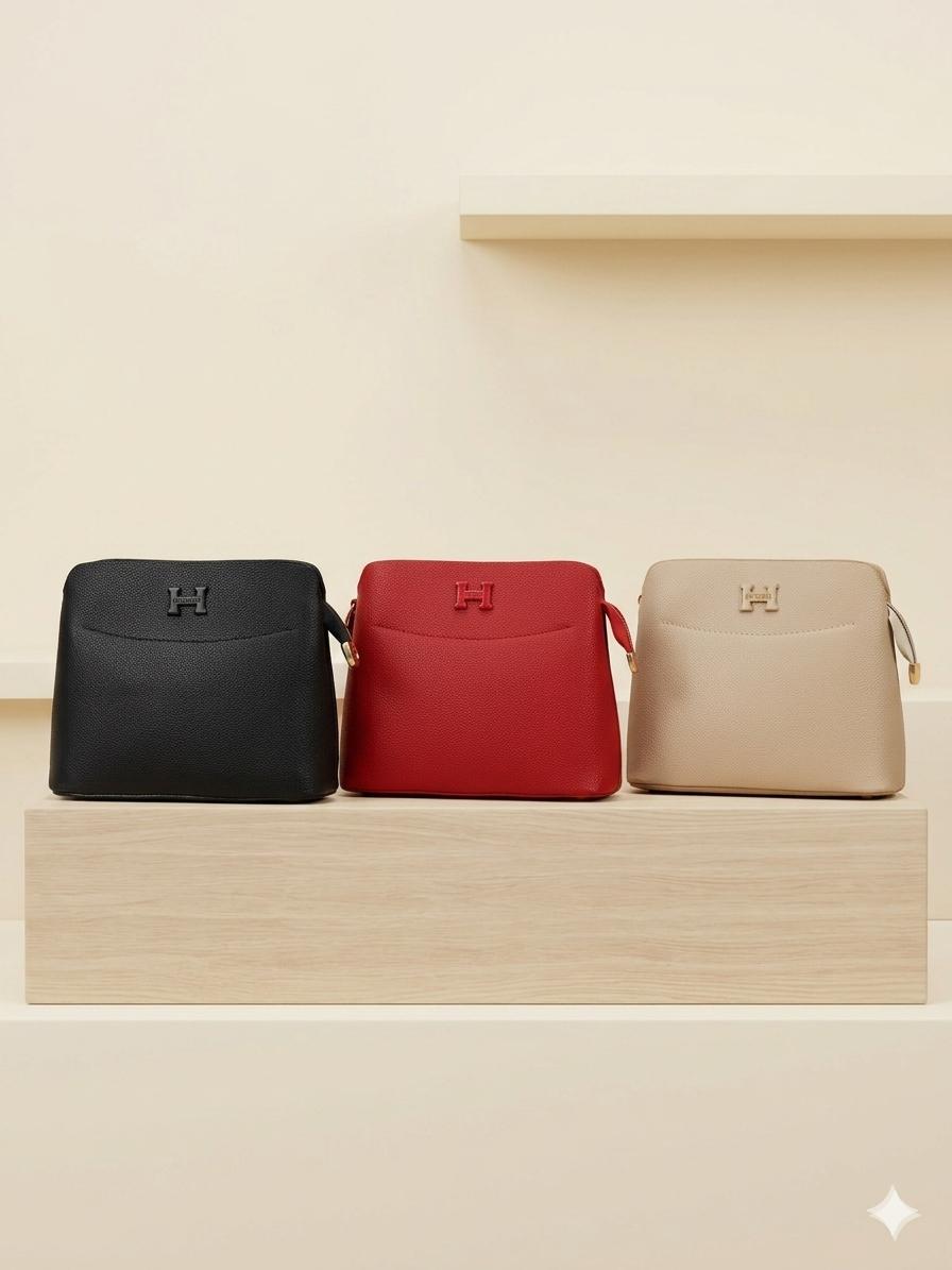Three bags in black, red, and beige on a wooden shelf with a neutral background