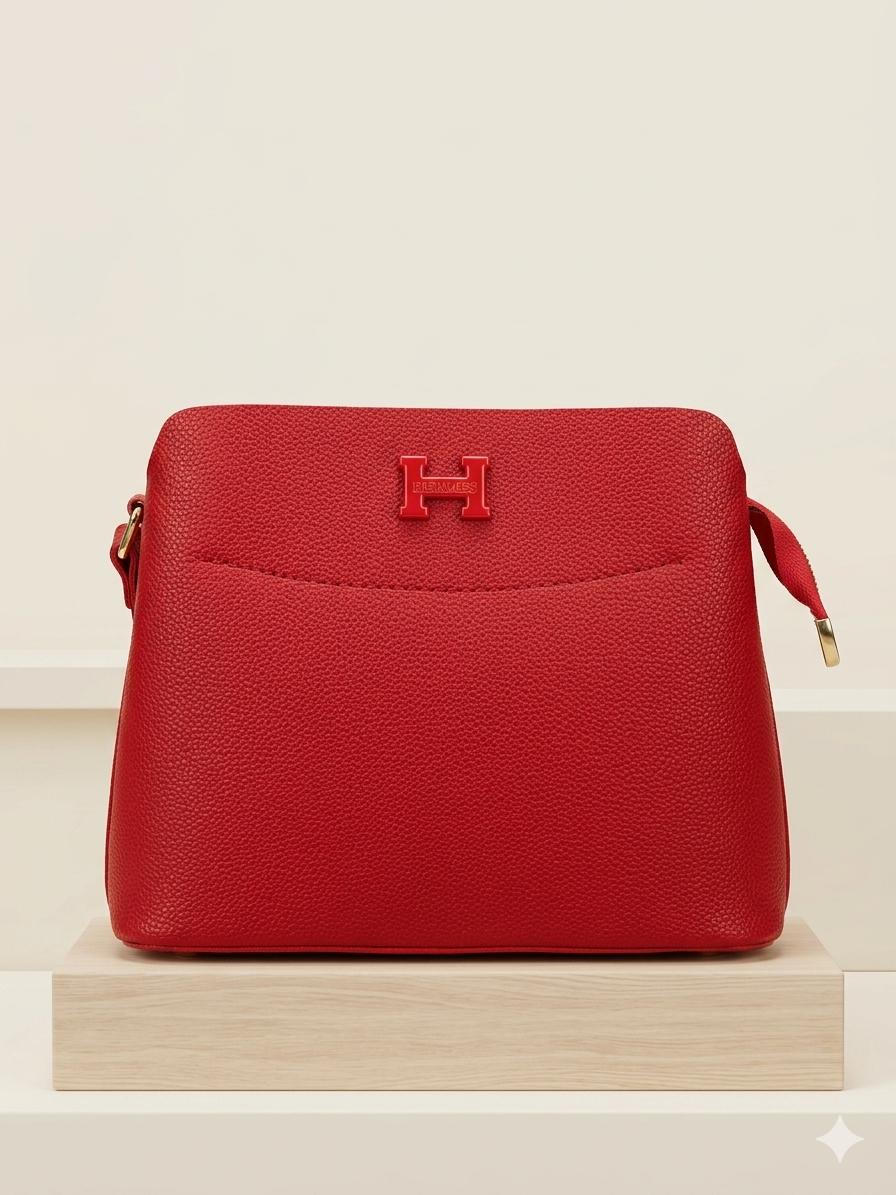Red handbag with a gold clasp on a beige background
